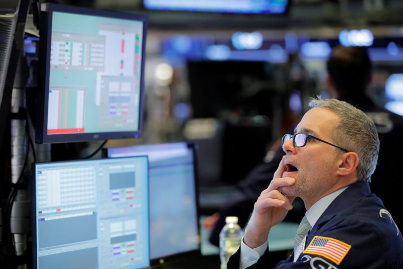 © Reuters. FILE PHOTO: A trader works on the floor of the New York Stock Exchange shortly after the opening bell in New York