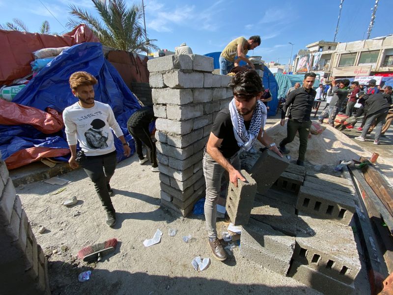 Iraqis rebuild wrecked protest camp as violence escalates