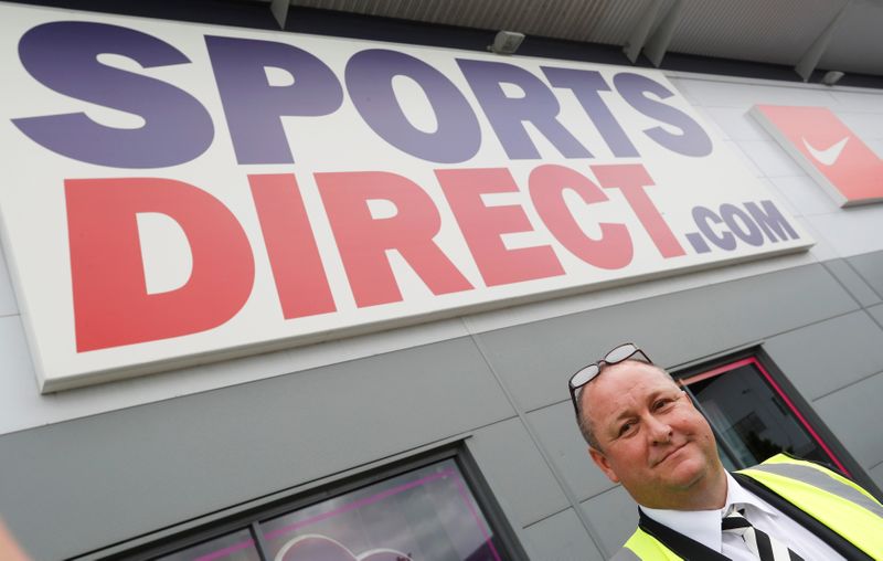 © Reuters. FILE PHOTO: Mike Ashley, founder and majority shareholder of sportwear retailer Sports Direct, leads journalists on a factory tour after the company's AGM, at the company's headquarters in Shirebrook