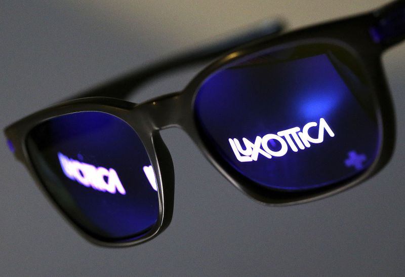 © Reuters. FILE PHOTO: The Luxottica name is reflected in a pair of sunglasses in this photo illustration taken in Rome