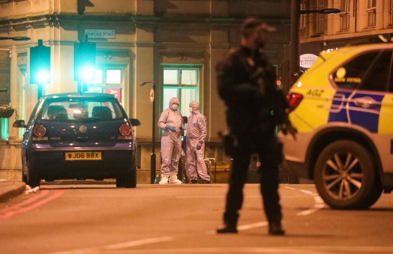 © Reuters. A police forensics officers are seen near a site where a man was shot by armed officers in Streatham, south London