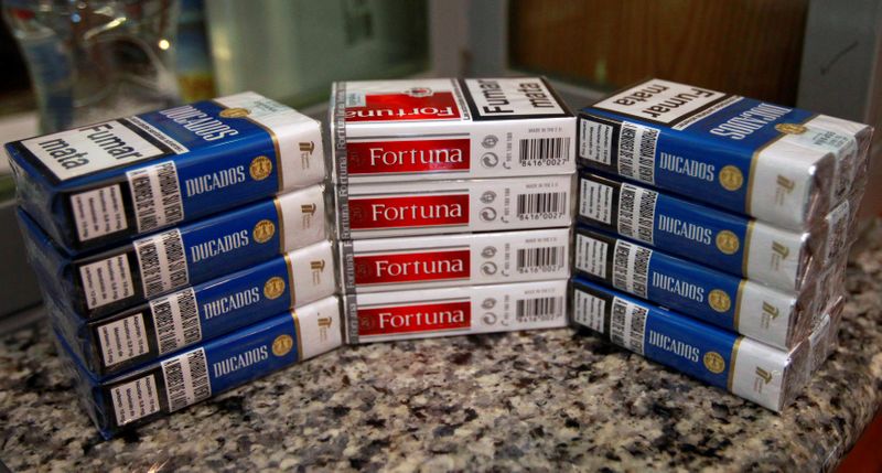 © Reuters. FILE PHOTO: Cigarette packs of Imperial Brands, are pictured at a tobacco store in Madrid, Spain