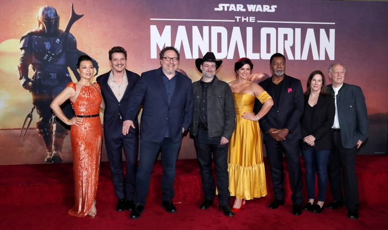 © Reuters. FILE PHOTO: Creator Favreau, President of Lucasfilm Kennedy, executive producer Filoni pose with cast members Wen, Pascal, Carano, Weathers and Herzog at the premiere for the television series "The Mandalorian" in Los Angeles