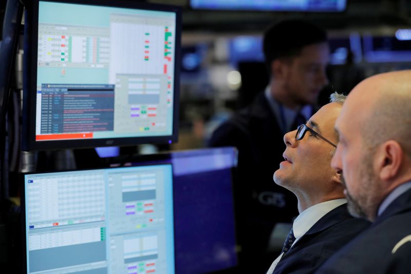 © Reuters. Traders work on the floor of the New York Stock Exchange shortly after the opening bell in New York