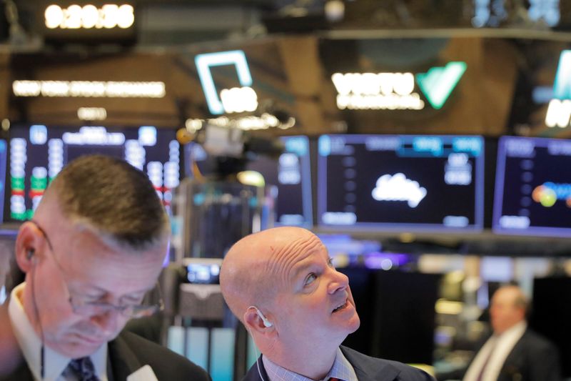 © Reuters. Traders work on the floor of the New York Stock Exchange shortly after the opening bell in New York