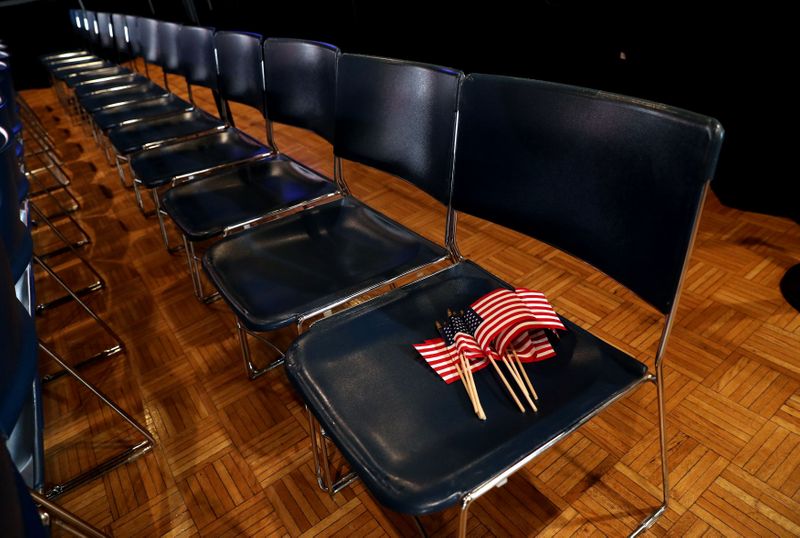 © Reuters. Flags are left on a seat before a rally by former Vice President Joe Biden in Des Moines