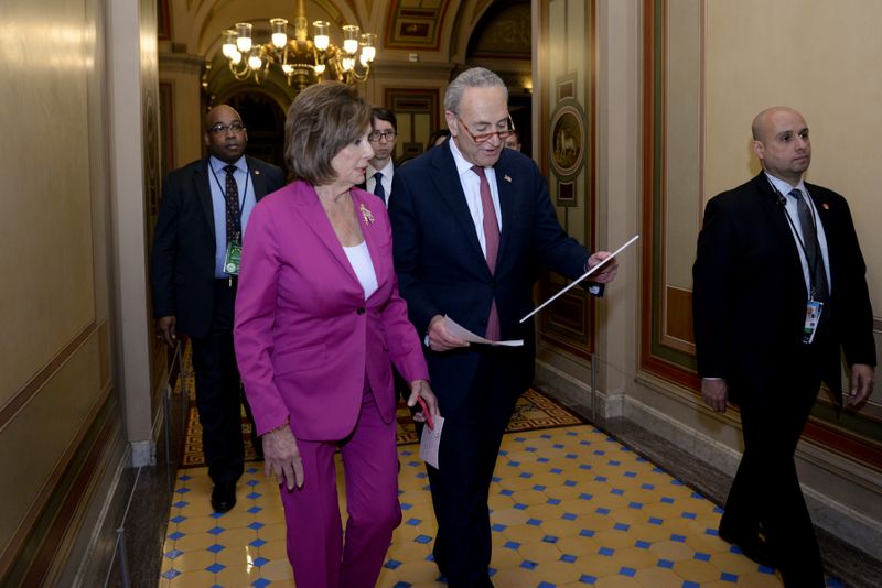 © Reuters. U.S. House Speaker Pelosi and Senate Minority Leader Schumer walk to a news conference at the U.S. Capitol in Washington