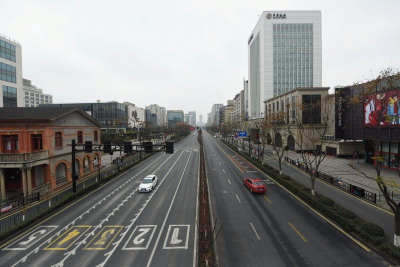 © Reuters. Cars travel on Yanan Road, a main commercial area in Hangzhou, after the city imposed new measures to prevent and control the new coronavirus