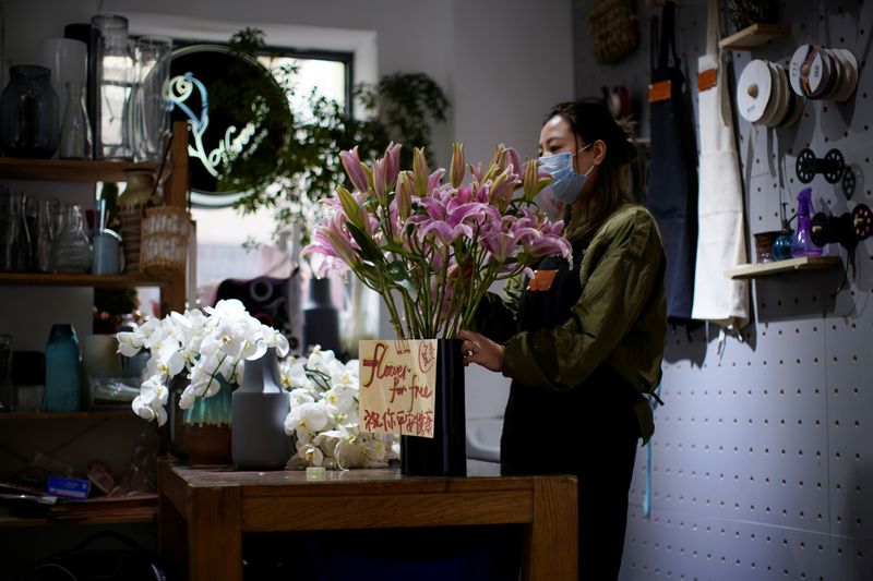 © Reuters. Florist Wang Haiyan, 41, works on flowers inside her shop as the country is hit by an outbreak of the new coronavirus, in Shanghai