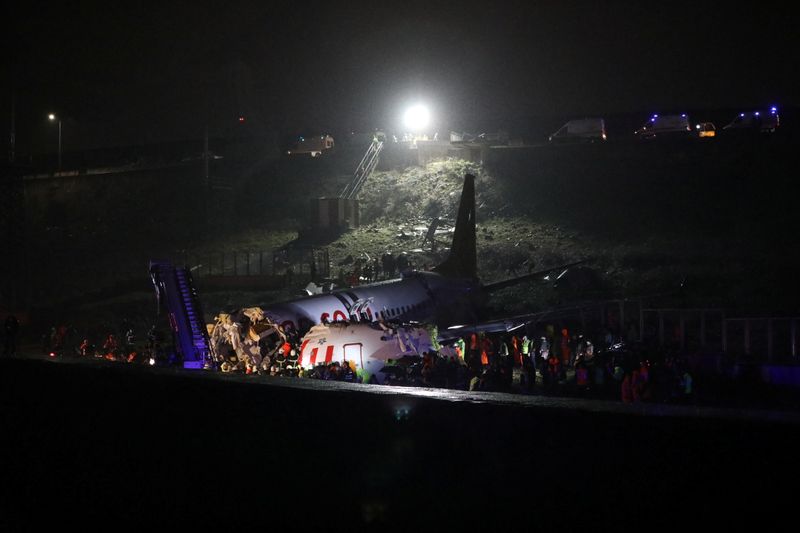 © Reuters. Bombeiros e membros da equipe de resgate perto de destroços de avião que caiu na Turquia