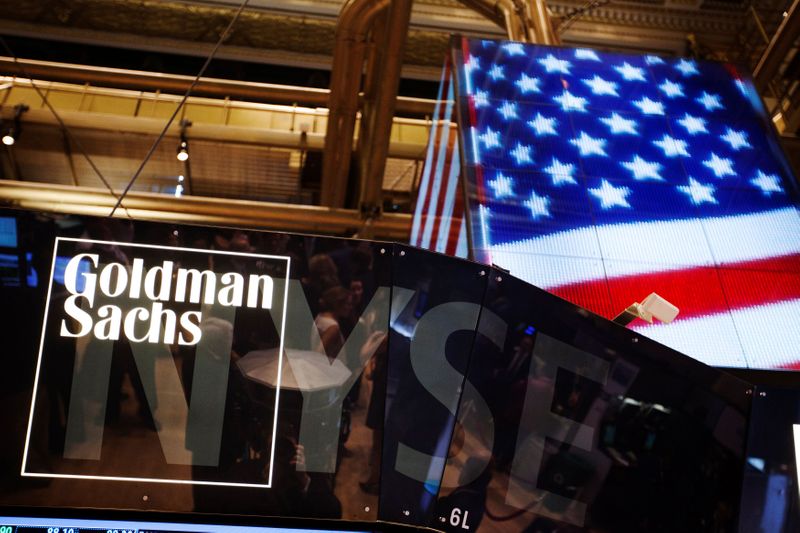 © Reuters. FILE PHOTO: The Goldman Sachs logo is displayed on a post above the floor of the New York Stock Exchange