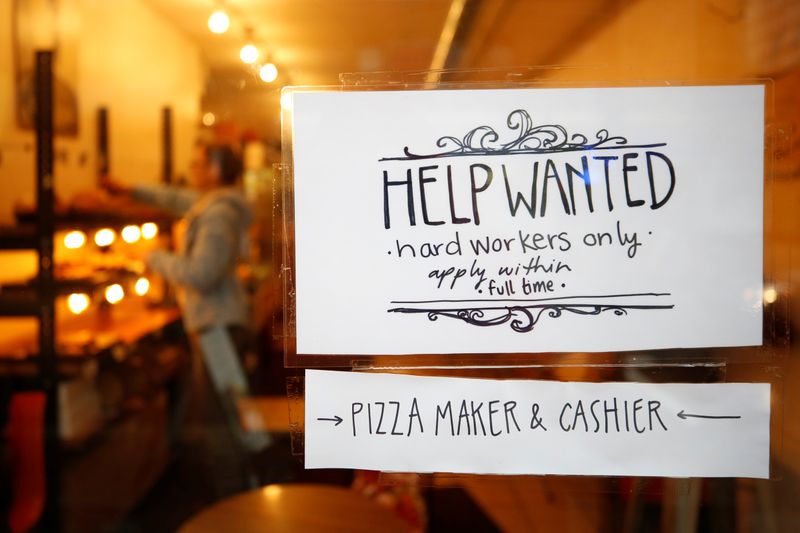 © Reuters. A "Help wanted" sign is seen in the window of a bakery in Ottawa