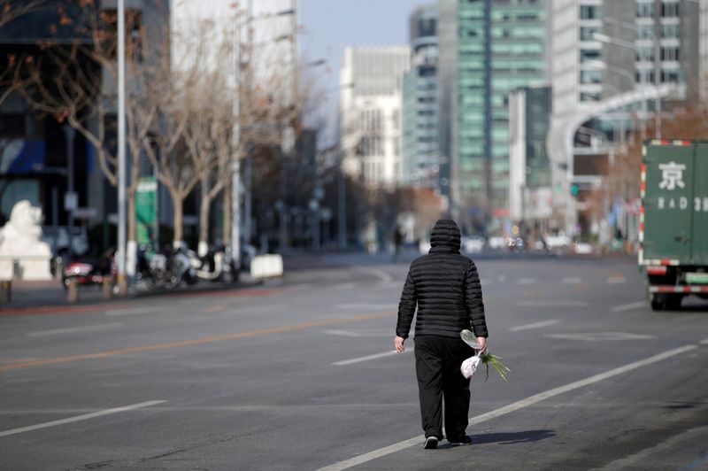 © Reuters. FILE PHOTO: Man walks along the Financial Street in central Beijing