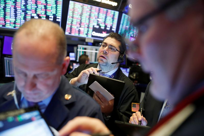 © Reuters. Traders work on the floor of the New York Stock Exchange shortly after the opening bell in New York