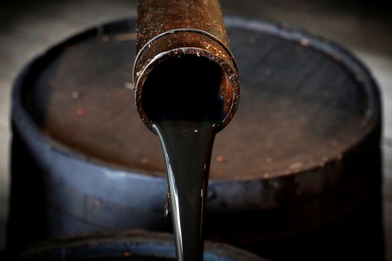 © Reuters. FILE PHOTO: Oil pours out of a spout from Edwin Drake's original 1859 well that launched the modern petroleum industry