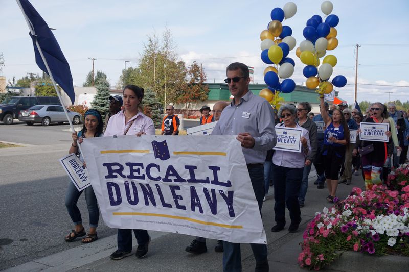 © Reuters. FILE PHOTO: People participate in a festive parade held by the Recall Dunleavy campaign seeking to oust Republican Gov. Mike Dunleavy and to deliver about 49,000 petition signatures in the first of two rounds required to get the measure on the ballot in An