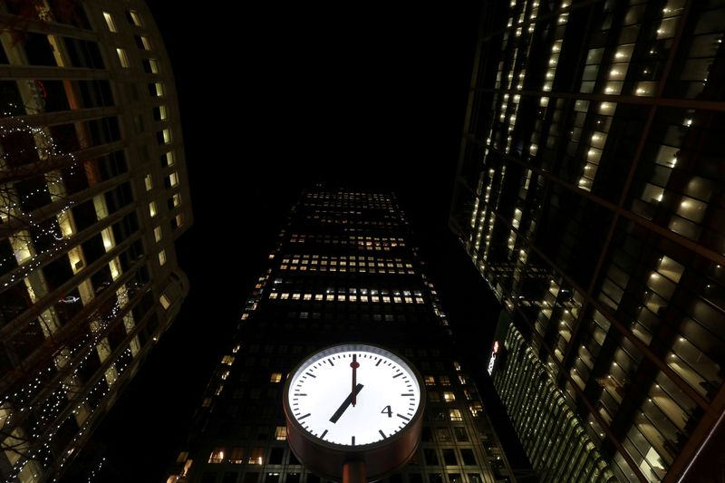 © Reuters. Clocks in London's Canary Wharf financial centre strike 07:00 GMT, marking the time the polls open for Britain's general election, London