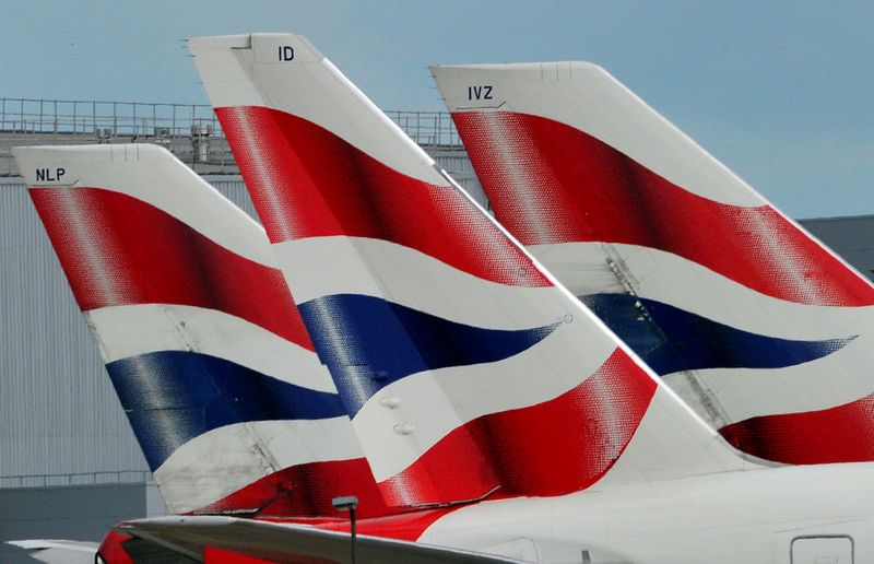 © Reuters. FILE PHOTO: British Airways logos are seen on tailfins at Heathrow Airport in west London