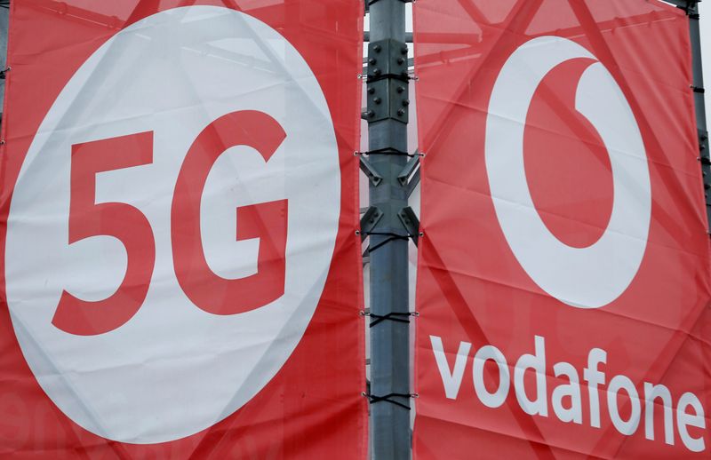 © Reuters. FILE PHOTO: Logos of 5G technology and telecommunications company Vodafone