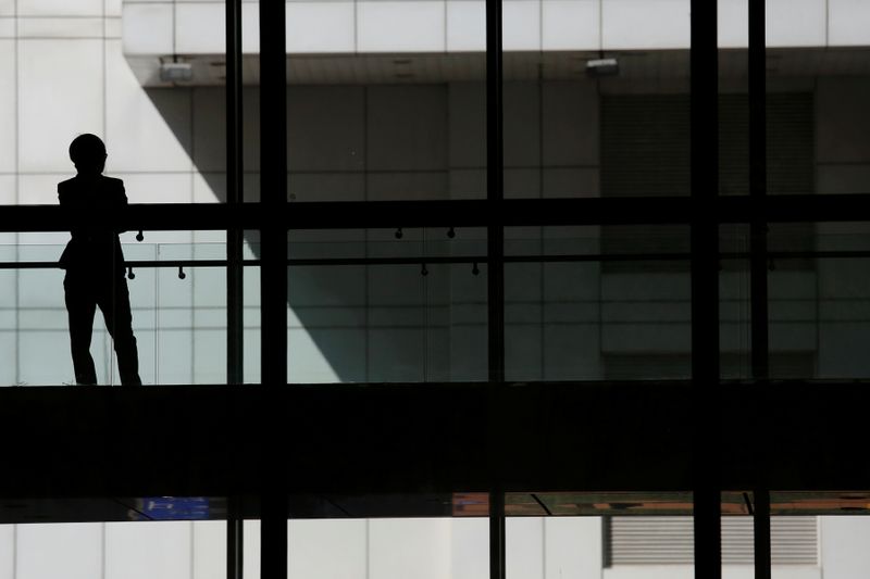 © Reuters. FILE PHOTO: A woman talks on phone inside the Bank of China head office building in Beijing