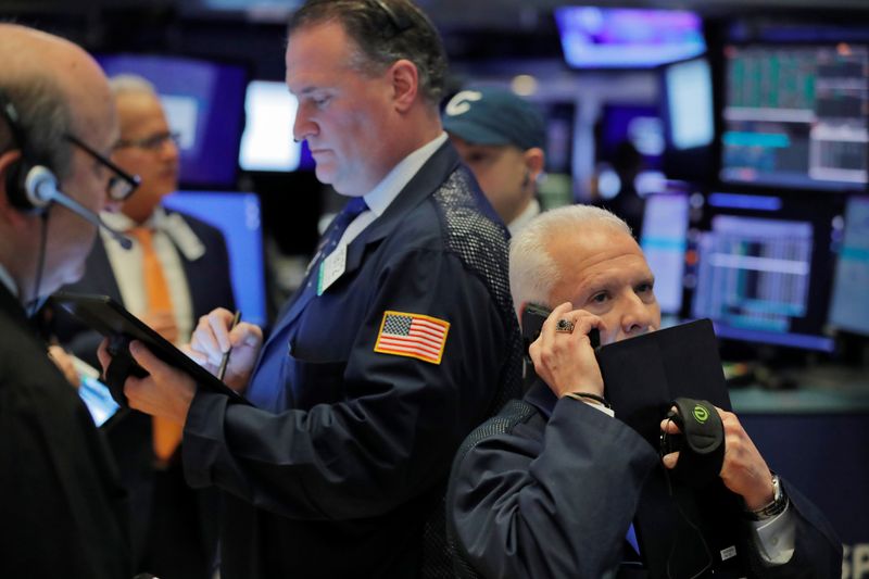 © Reuters. Traders work on the floor of the New York Stock Exchange shortly after the opening bell in New York