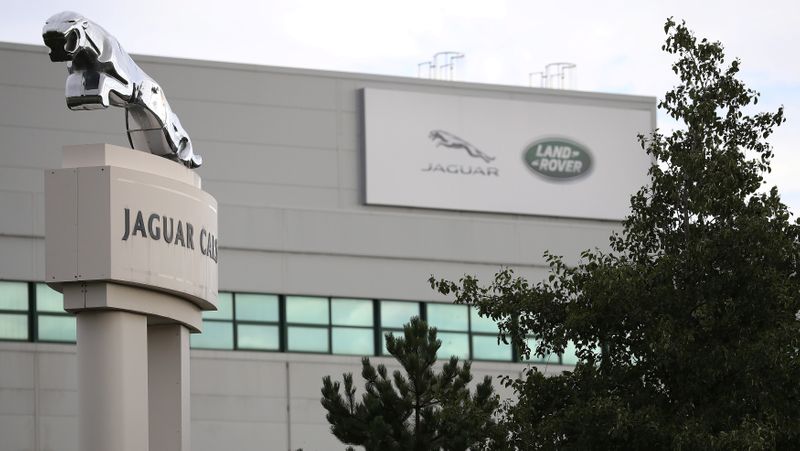 © Reuters. FILE PHOTO: Signs are seen outside the Jaguar Land Rover plant at Halewood in Liverpool, northern England.