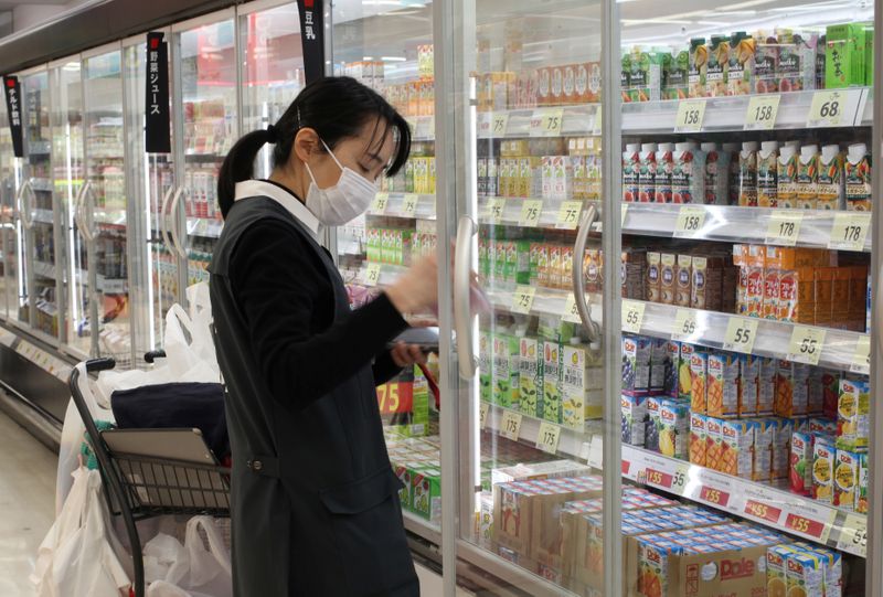 © Reuters. An employee picks out products to fulfil online orders at a Seiyu store in Tokyo