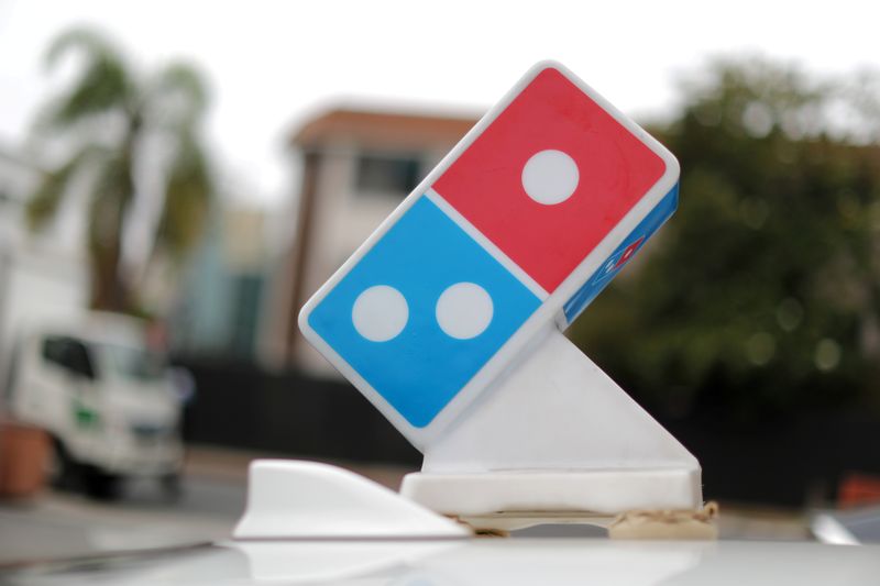 © Reuters. FILE PHOTO: A Domino's Pizza sign sits on the top of a delivery car outside a restaurant in Los Angeles