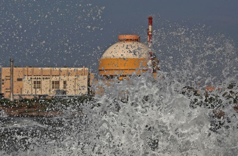 © Reuters. FILE PHOTO: waves hit the rocks as Kudankulam nuclear power project plant is seen in the background