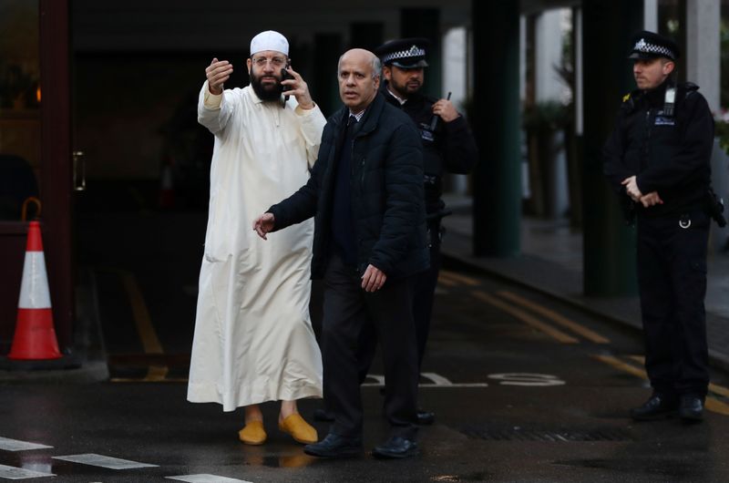 © Reuters. A man gestures as Police officers are seen outside the London Central Mosque in London