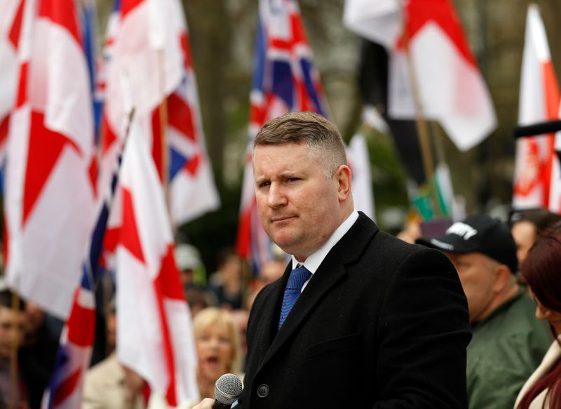 UK far-right group leader charged over refusing to give phone code - BBC