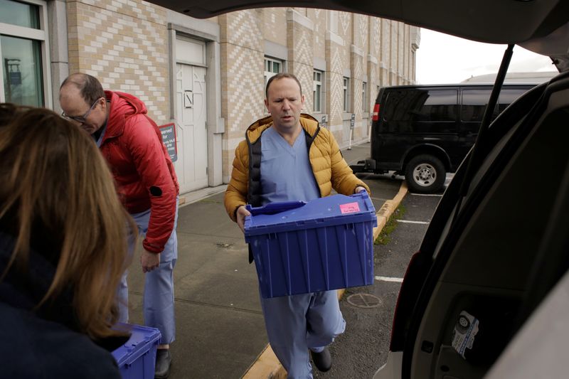 © Reuters. Harborview Medical Center's home assessment team load protective and testing supplies into a van while preparing to visit the home of a person potentially exposed to novel coronavirus at Harborview Medical Center in Seattle