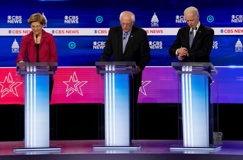 © Reuters. FILE PHOTO: Candidates during pause during a break at the tenth Democratic 2020 presidential debate at the Gaillard Center in Charleston, South Carolina, U.S.