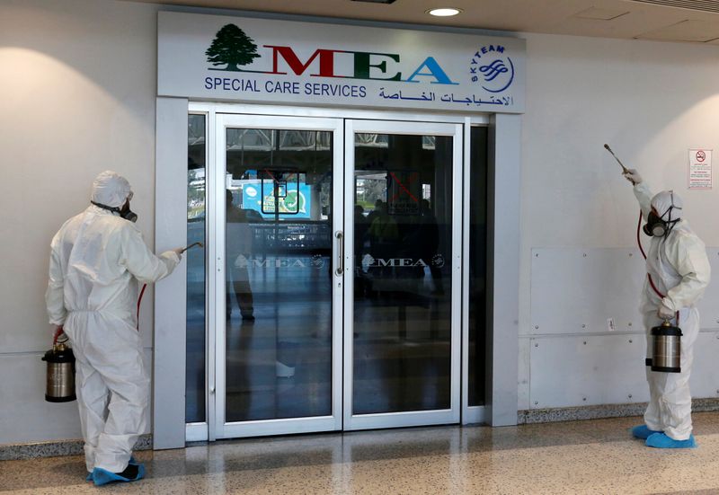 © Reuters. Workers sanitize Beirut international airport, as a precaution against the spread of the coronavirus