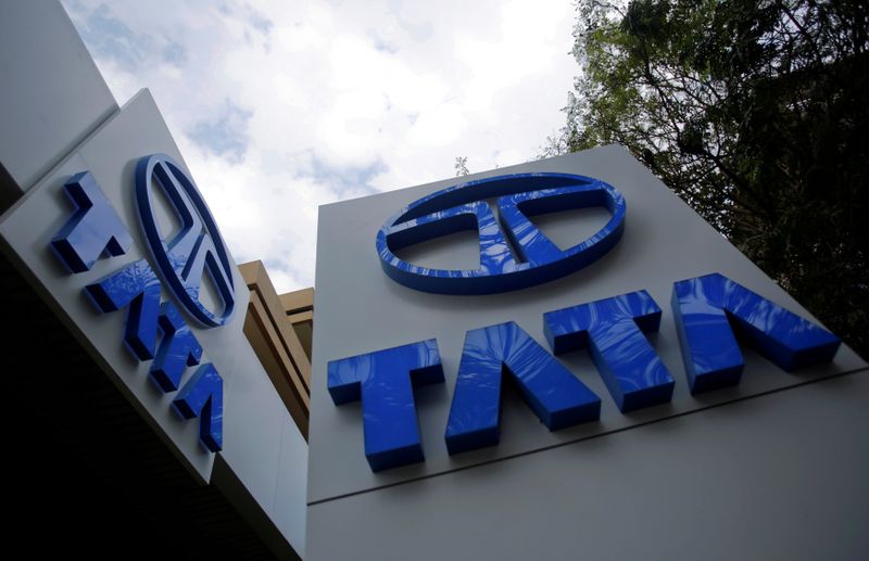 © Reuters. FILE PHOTO: Tata Motors logos are seen at their flagship showroom before the announcement of their Q3 results in Mumbai