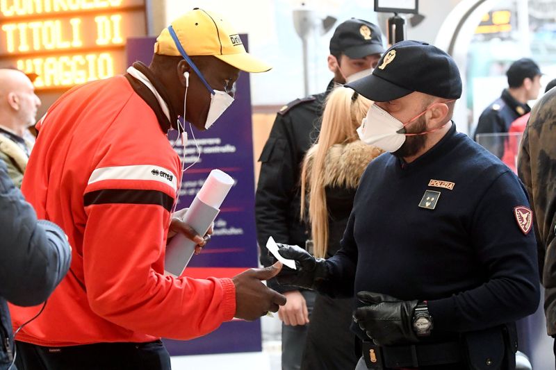 © Reuters. Police officers make checks on people at Milan's main train station