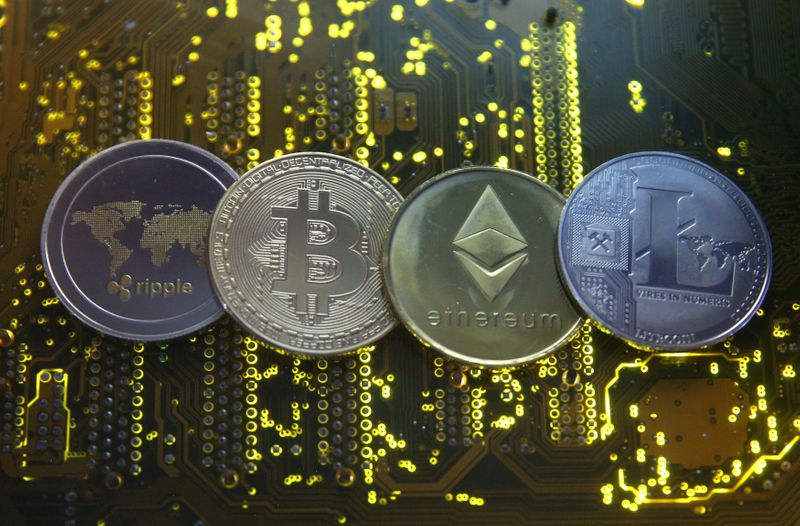 © Reuters. Representations of the Ripple, Bitcoin, Etherum and Litecoin virtual currencies are seen on motherboard in this illustration picture