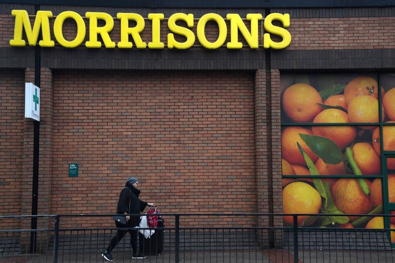 © Reuters. A shopper walks past a branch of the food retailer Morrisons in west London, Britain