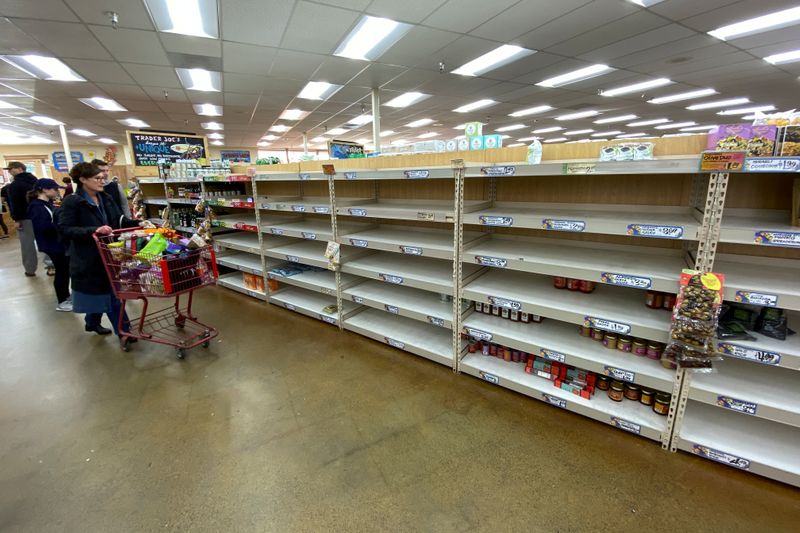 © Reuters. Shelves previously filled with pasta and canned food are seen empty at a Trader Joe's grocery store as shoppers gather supplies with coronavirus fears spreading in Encinitas, California
