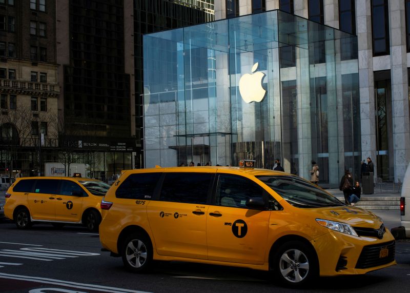 © Reuters. A cab drives down 5av while Apple store is seen closed to public due to COVID-19 in New York City, New York