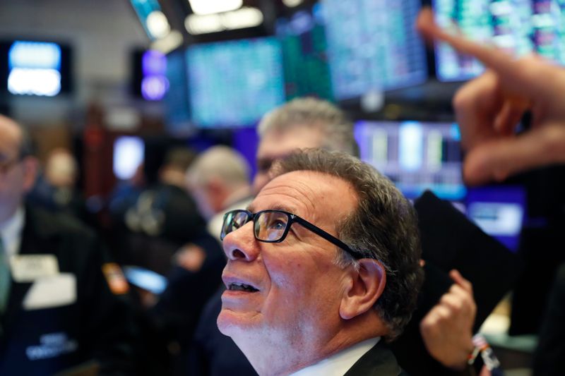 © Reuters. Traders work on the floor of the New York Stock Exchange (NYSE) after the opening bell of the trading session in New York