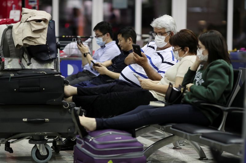 © Reuters. Viajantes utilizam máscaras de proteção contra coronavírus no aeroporto de Guarulhos (SP)