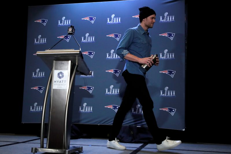 © Reuters. FILE PHOTO: New England Patriots quarterback Tom Brady walks from the podium after speaking at a press conference ahead of Super Bowl LIII in Atlanta