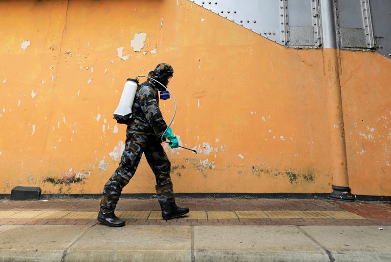 © Reuters. An airforce member sprays disinfectant inside a main railway station, as the number of people tested positive for coronavirus disease in the country increased, in Colombo