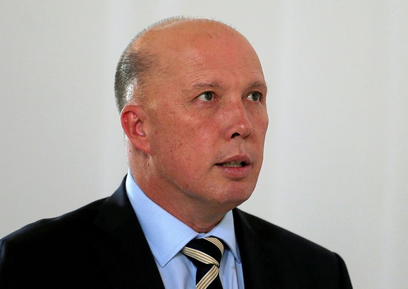 © Reuters. FILE PHOTO: Australian Minister of Home Affairs Peter Dutton inspects St. Sebastian's Church where two Australian citizens died in the Easter Sunday bombing, during his visit to Negombo