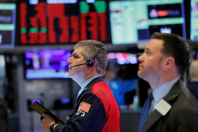 © Reuters. FILE PHOTO: Traders work on the floor of the New York Stock Exchange shortly after the opening bell as trading is halted in New York