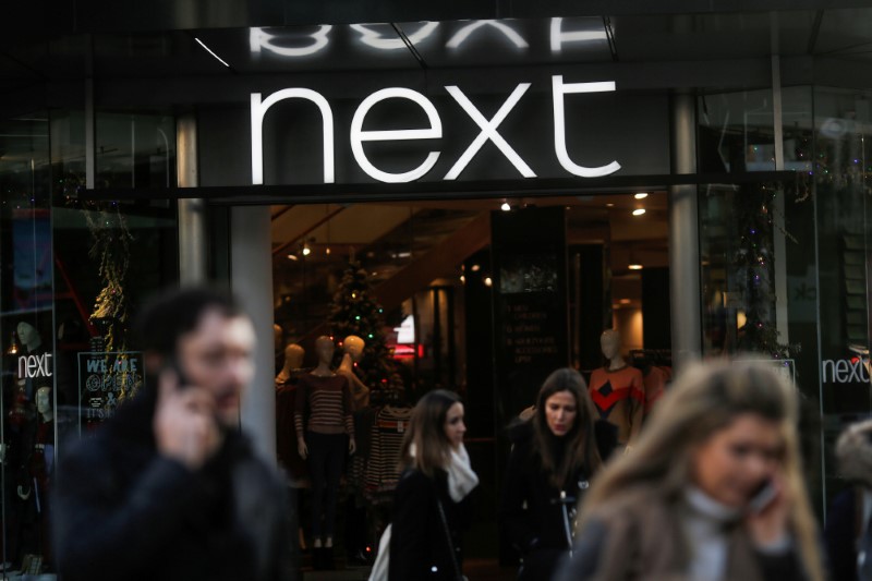 © Reuters. FILE PHOTO: Shoppers walk past a Next store on Oxford Street in London
