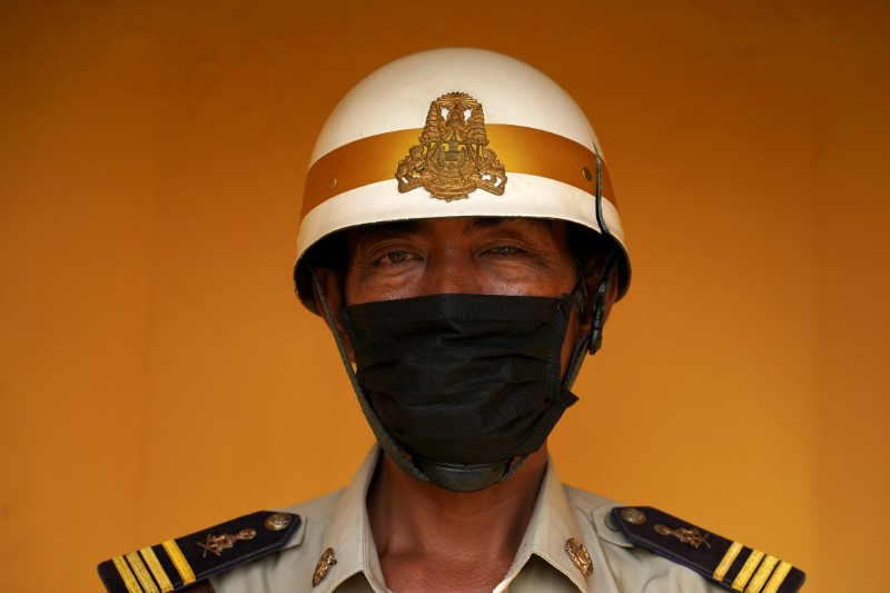 &copy; Reuters. A guard outside the Royal Palace wears a protective mask as precaution against the coronavirus outbreak in Phnom Penh, Cambodia