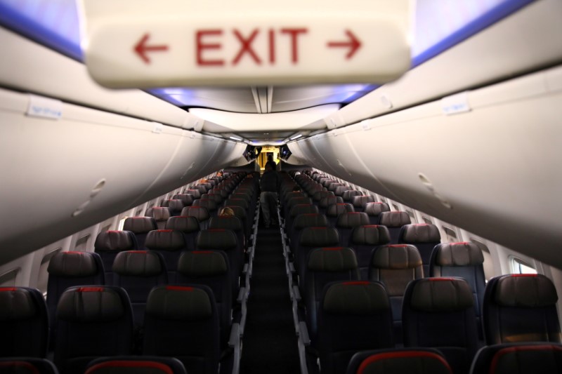 © Reuters. FILE PHOTO: Rows of empty seats of an American Airline flight are seen, as coronavirus disease (COVID-19) disruption continues across the global industry, during a flight between Washington D.C. and Miami, in Washington, U.S.