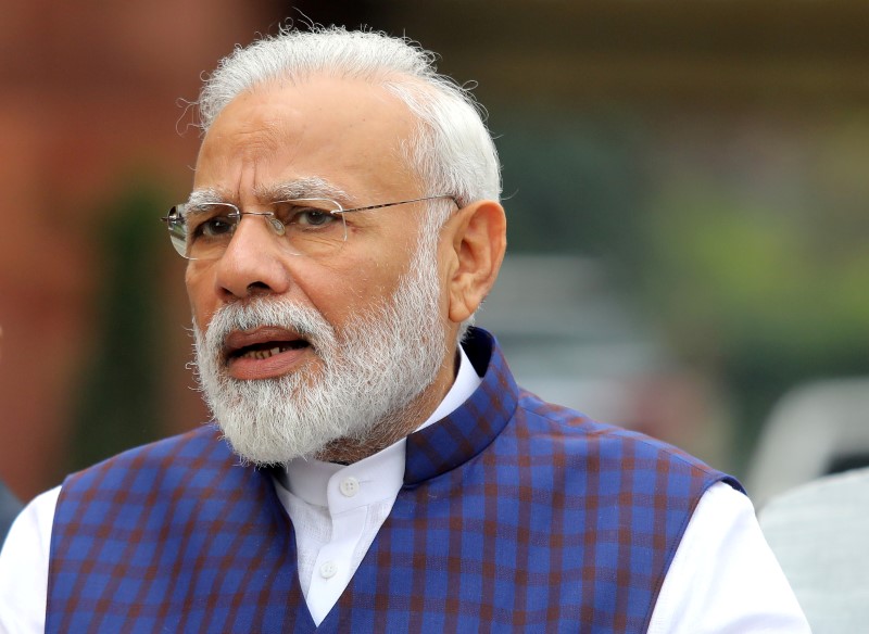 © Reuters. FILE PHOTO: India's PM Modi speaks to the media inside the parliament premises on the first day of the winter session in New Delhi